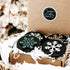 Set of 8 black wooden snowflake ornaments with white and gold snowflake designs