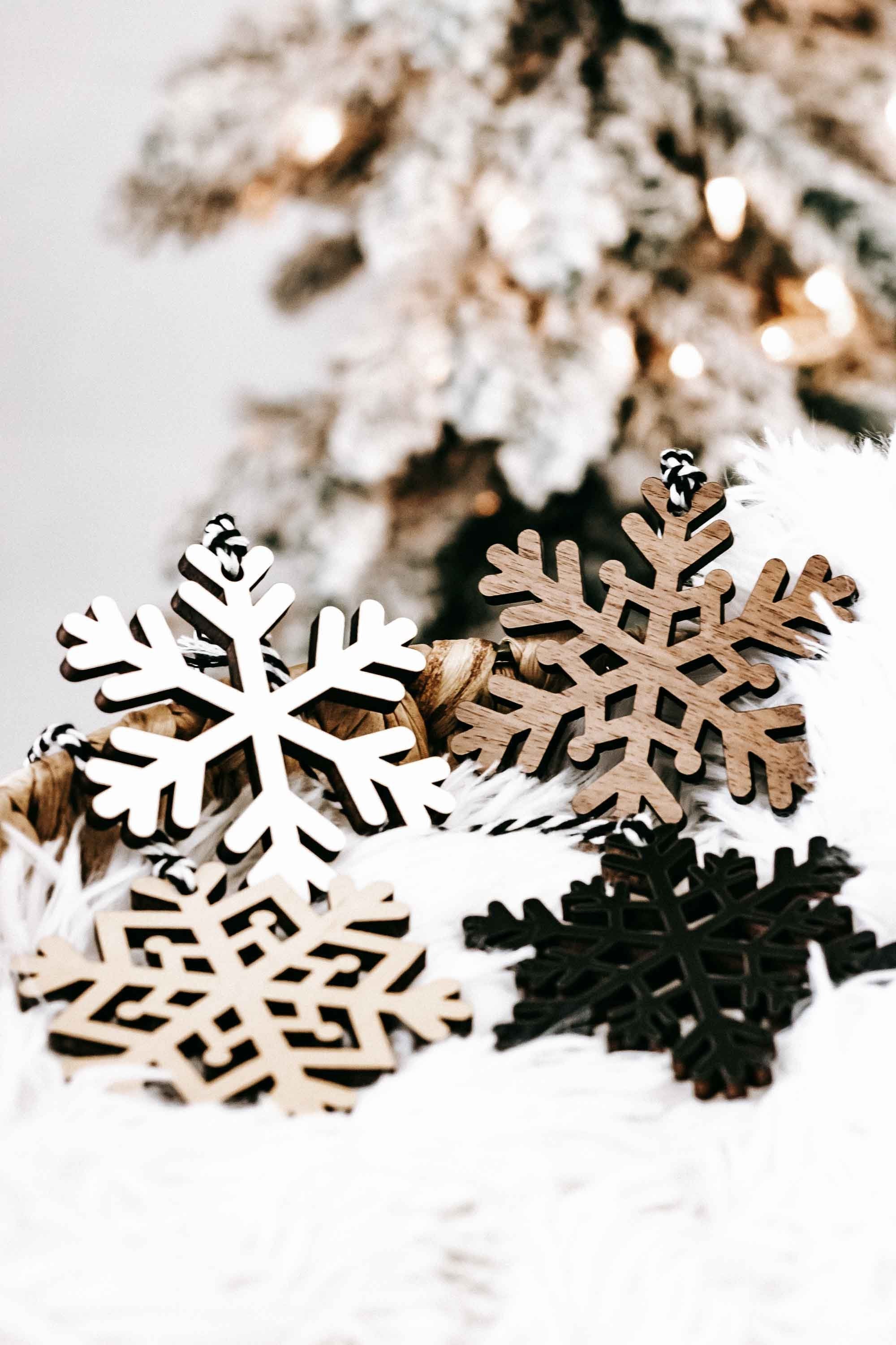Wood snowflake ornament set close-up: white, tan, and dark snowflake cutouts
