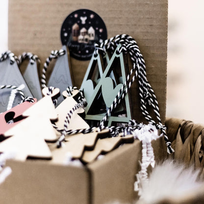 Set of 16 boho wood Christmas ornaments with tree cutouts and striped cords in gift box