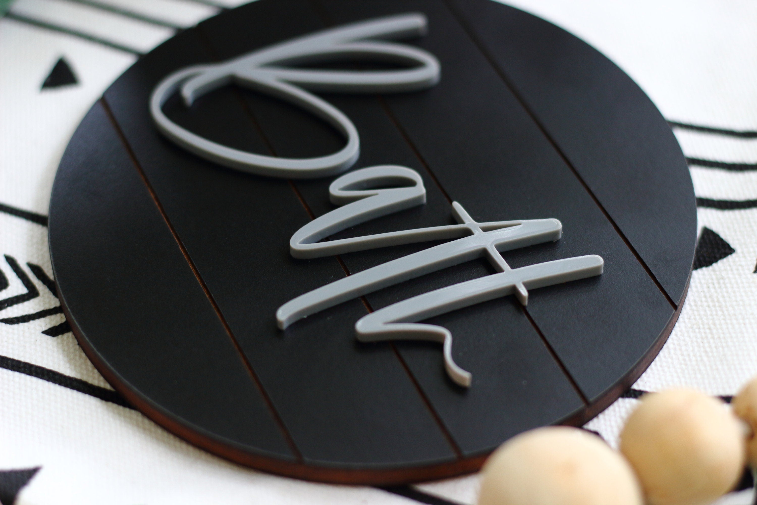 Round dark bath wall sign with 3D light “Bath” lettering