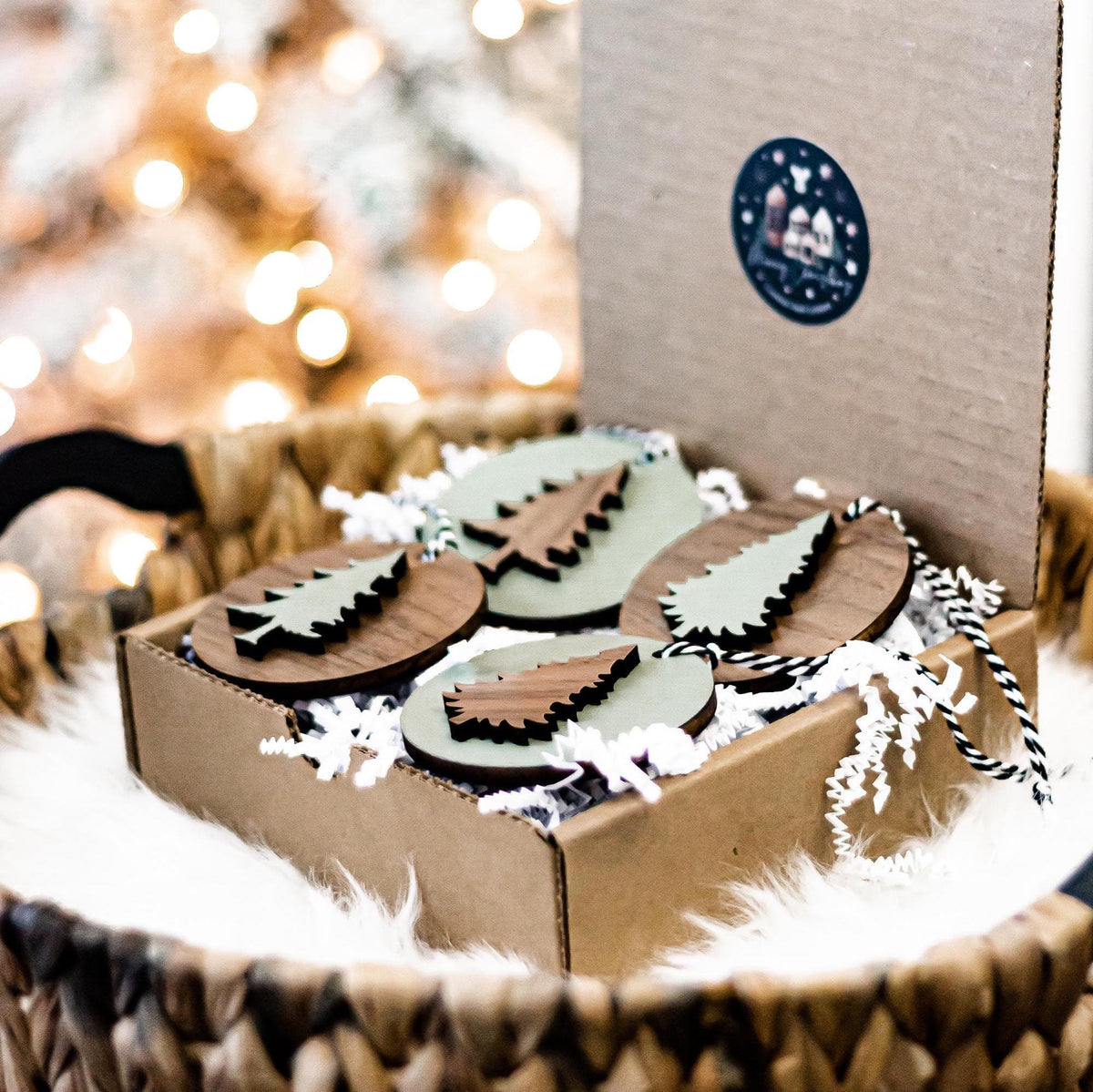 Set of wooden Christmas tree ornaments in a gift box, with striped hanging cords
