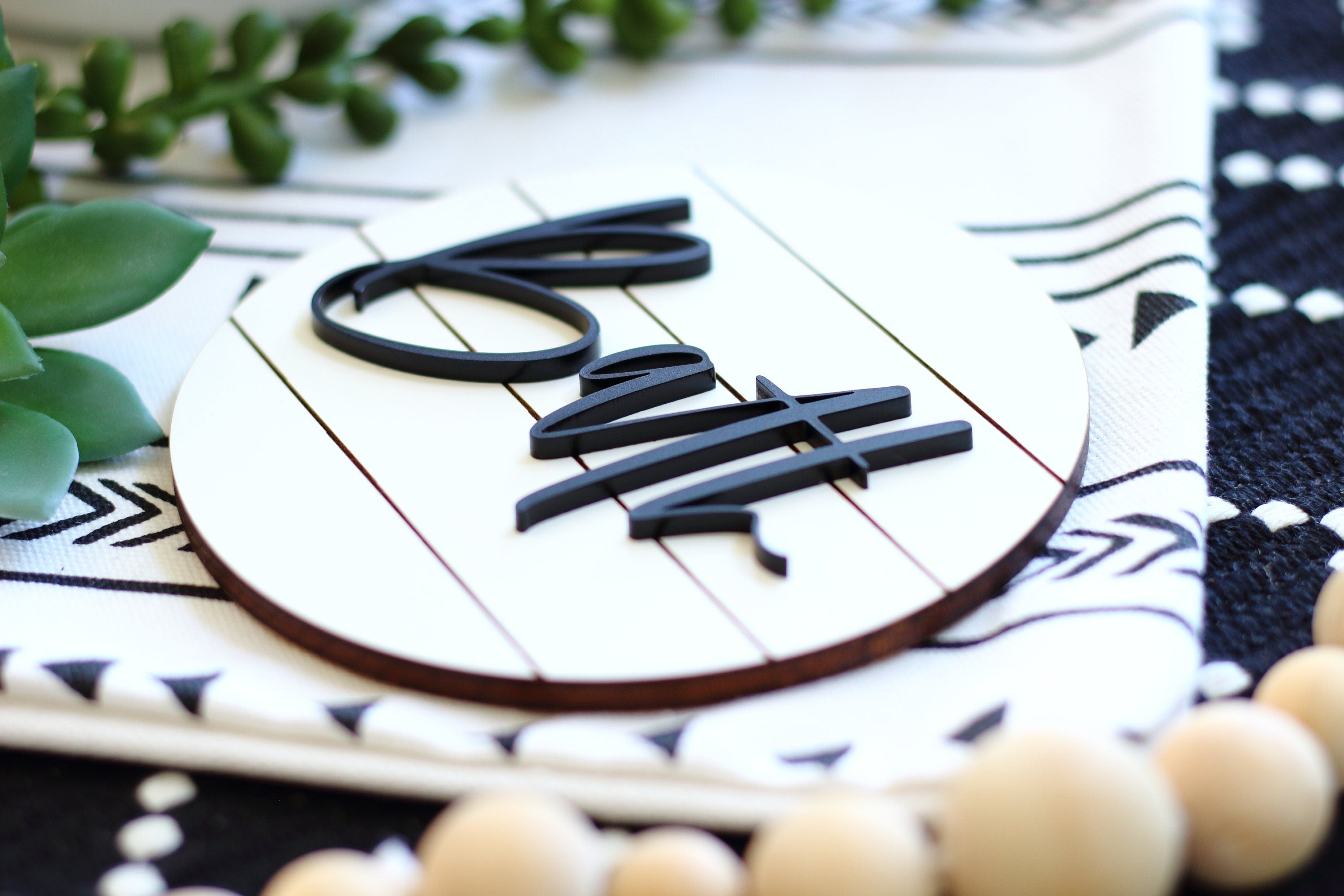 Wood bath wall sign with 3D black “Bath” lettering on a circular board