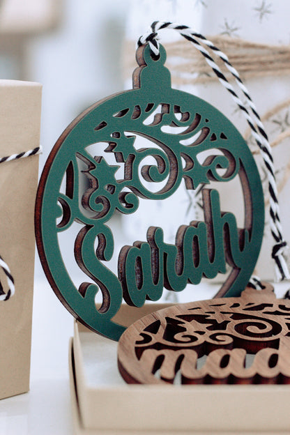 Green laser-cut name ornament with decorative stars, in gift box