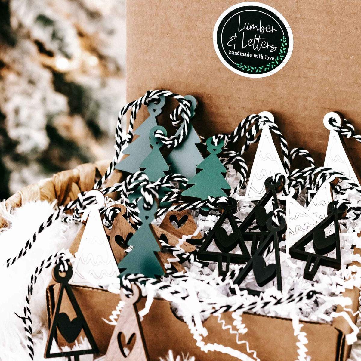Set of mini wooden Christmas tree ornaments with hanging loops, green and black accents