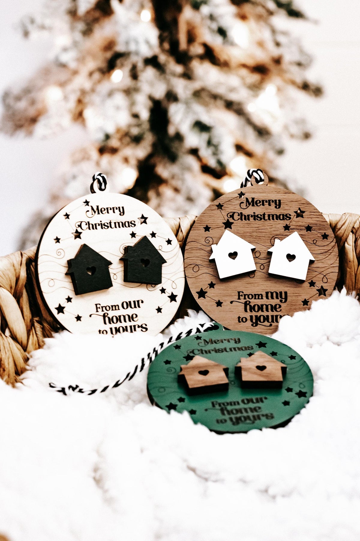 Two hanging round wooden Christmas ornaments with house icons and “From my home to yours”