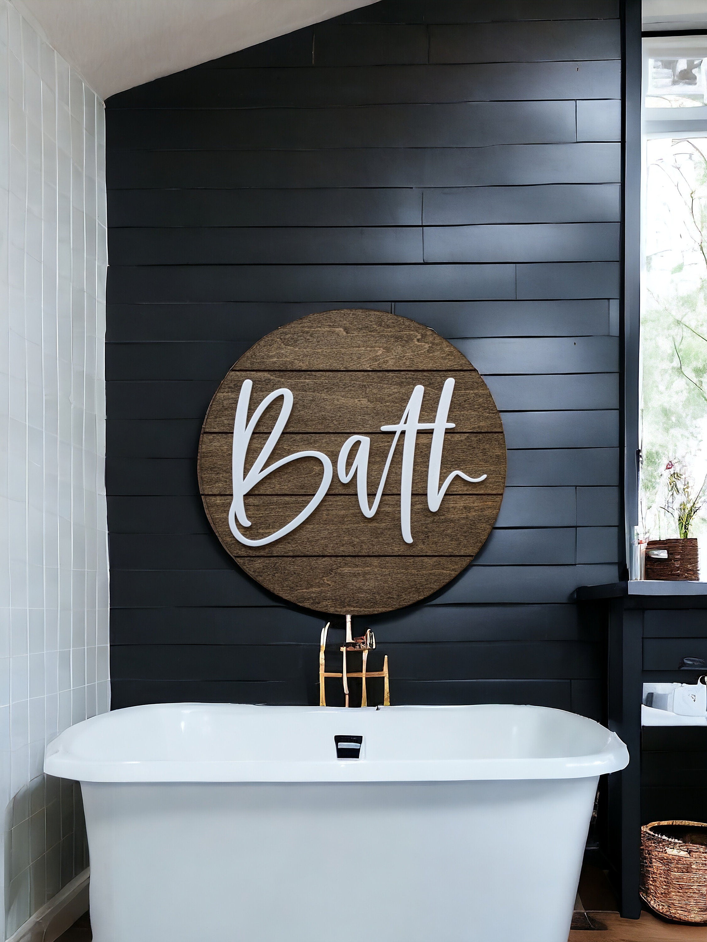 Round wood bath wall sign with white “Bath” lettering on a dark wall