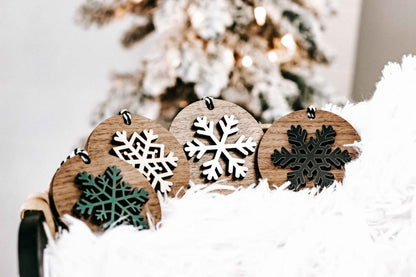 Wooden snowflake ornaments set with round wood backs, striped hanging loops and mixed colors
