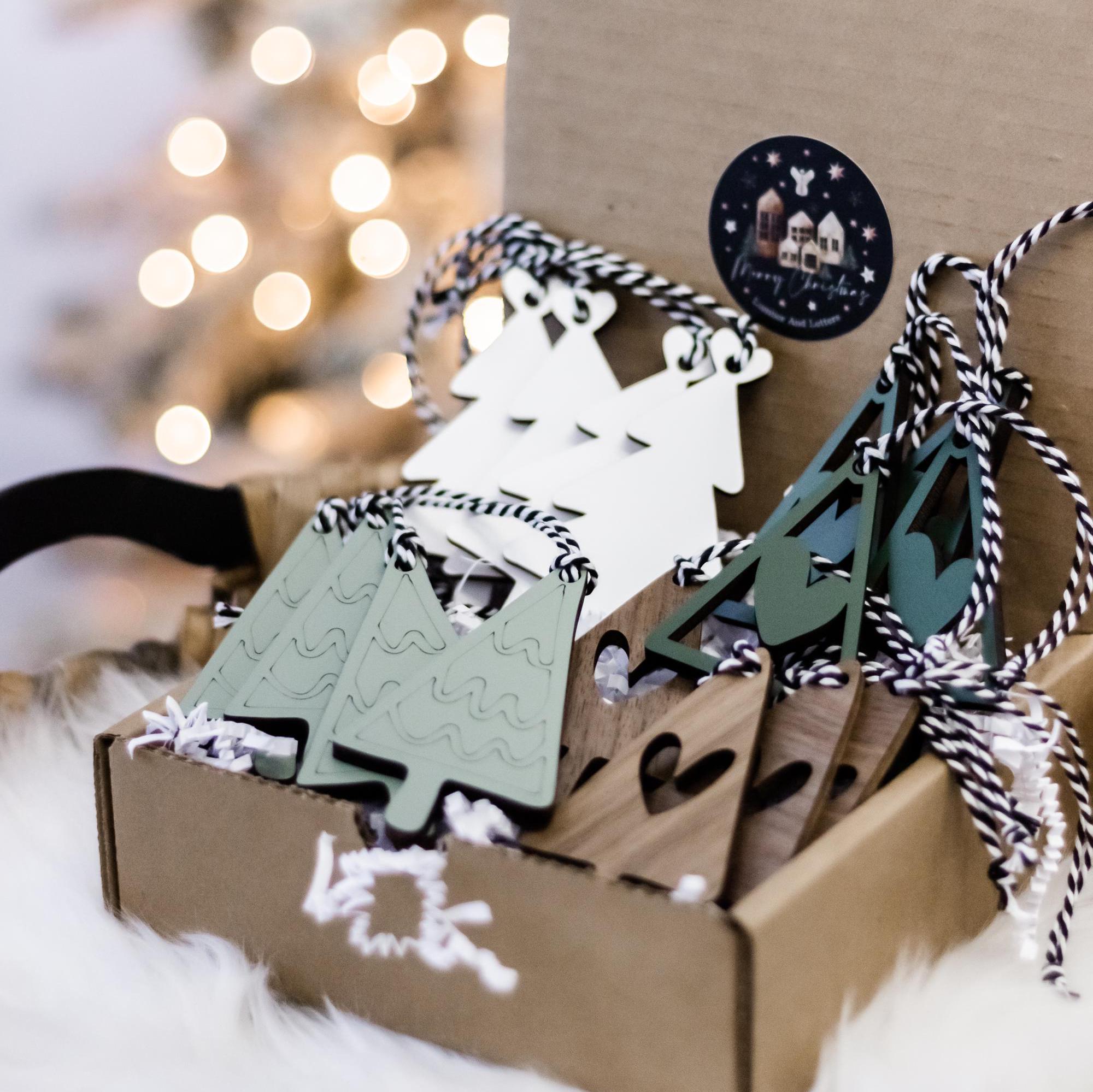 Christmas ornament set: white tree cutouts and green trees in kraft display box
