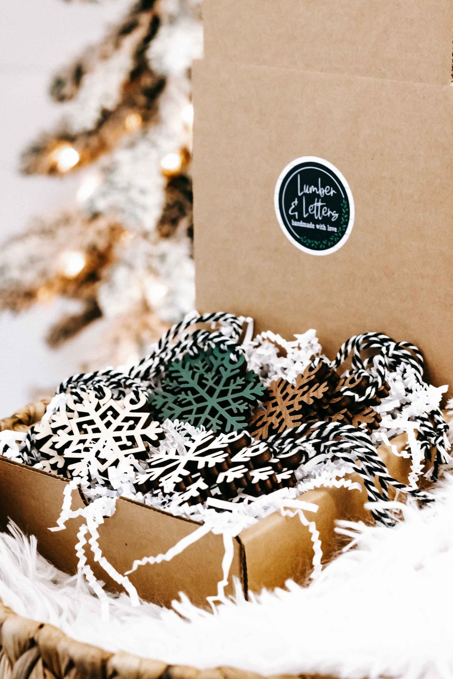 Set of 16 snowflake tree ornaments, kraft box with white cutouts and green-dark accents