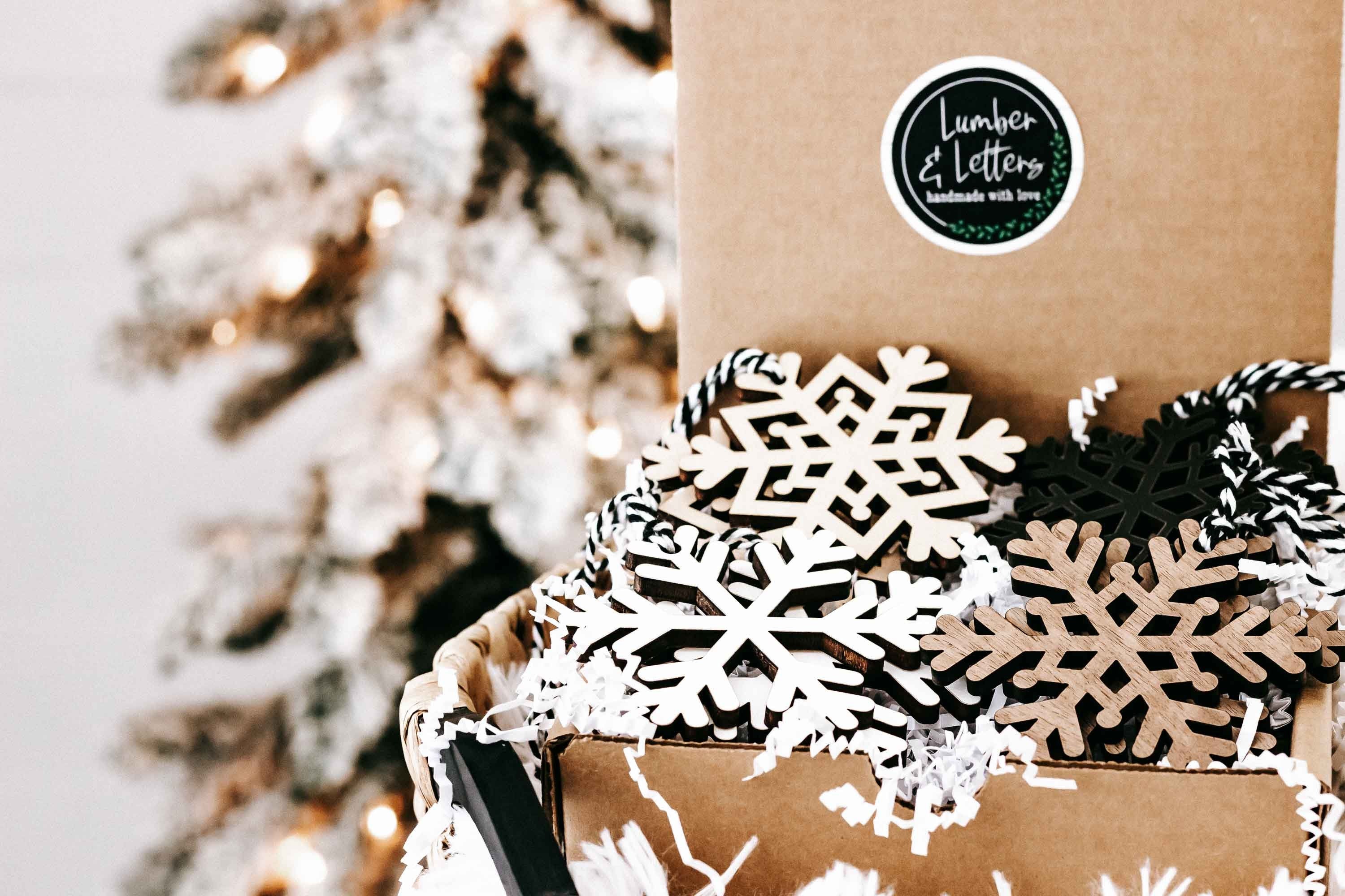 Snowflake ornament set in a gift box: white lattice and dark snowflake cutouts