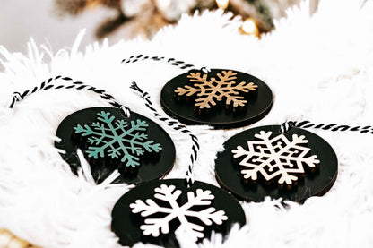 Set of 8 black wooden snowflake ornaments with white and gold snowflake designs