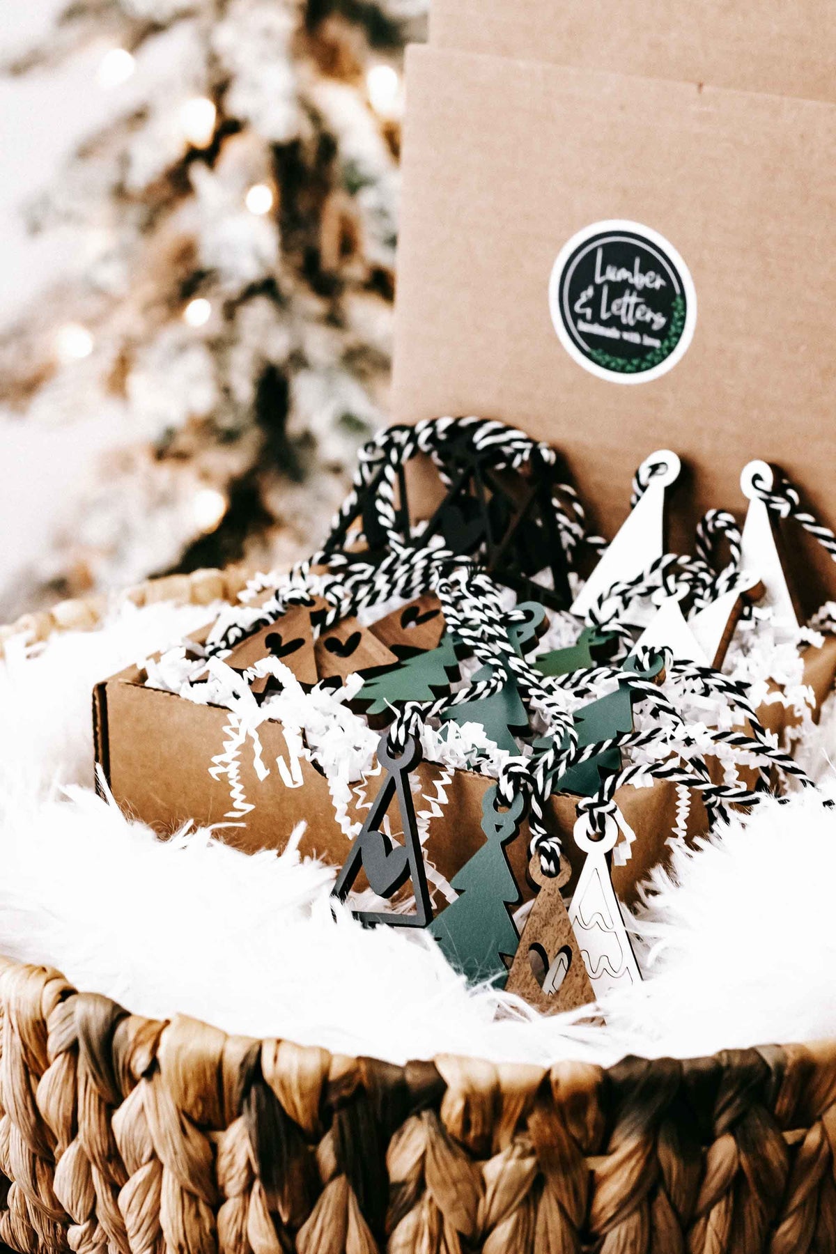 Mini wooden Christmas tree ornaments with hanging loops, featuring green tree and brown houses