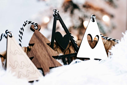 Assorted boho Christmas tree ornaments with striped rope hangers in black, white, and wood