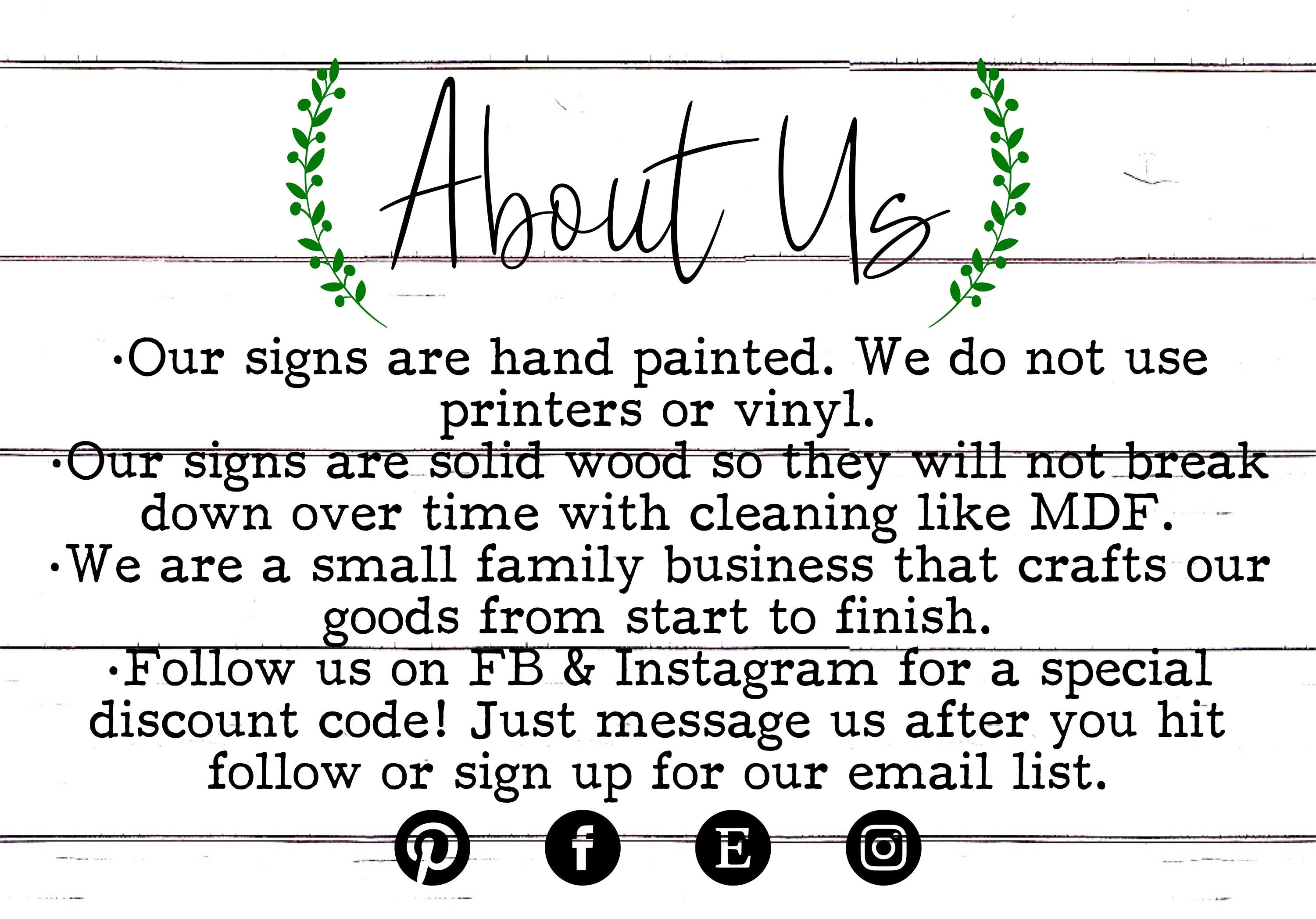 About Us sign card with green wreath and printed text on light background