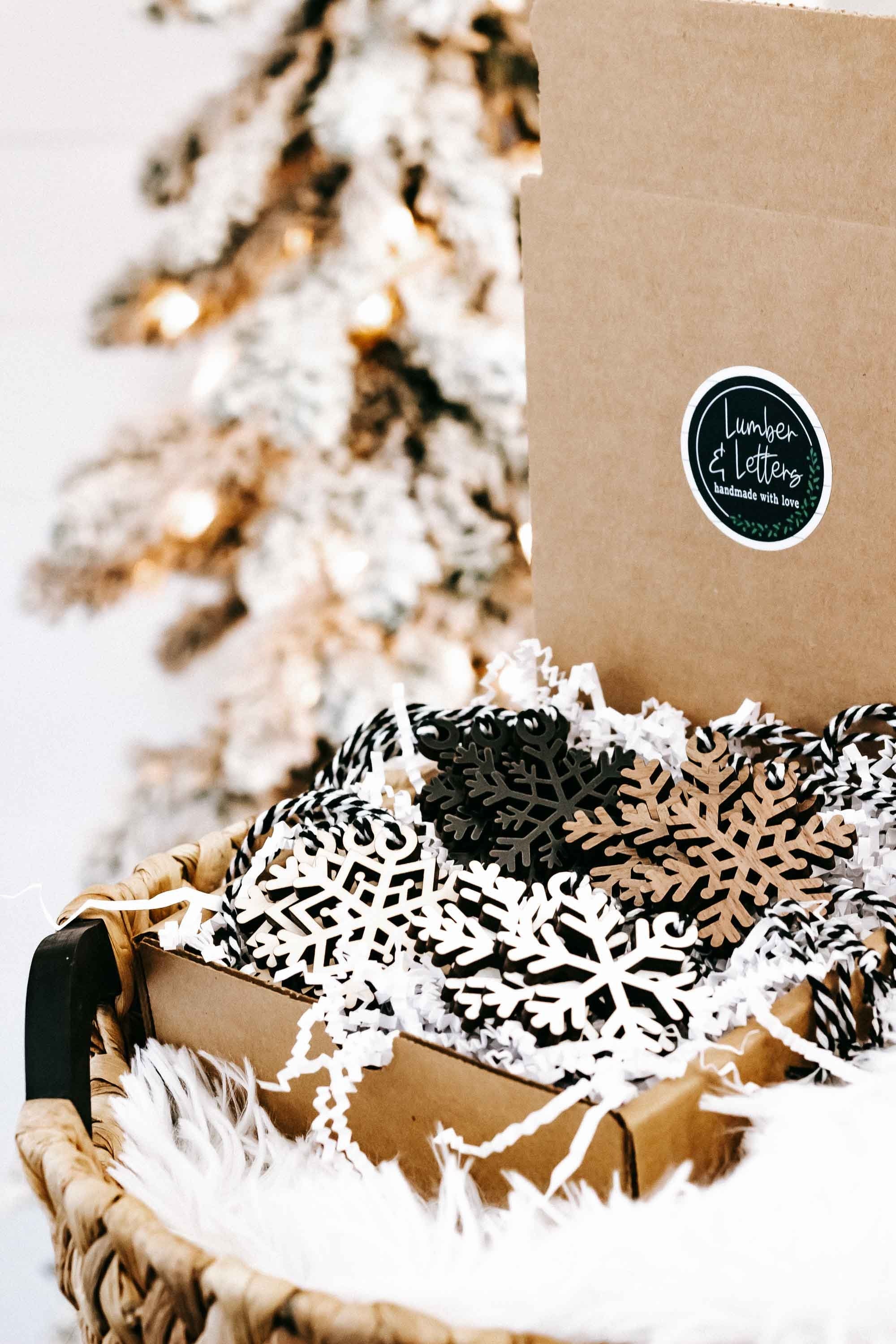 Snowflake wooden ornaments in a kraft box with white faux fur and mixed black and beige designs