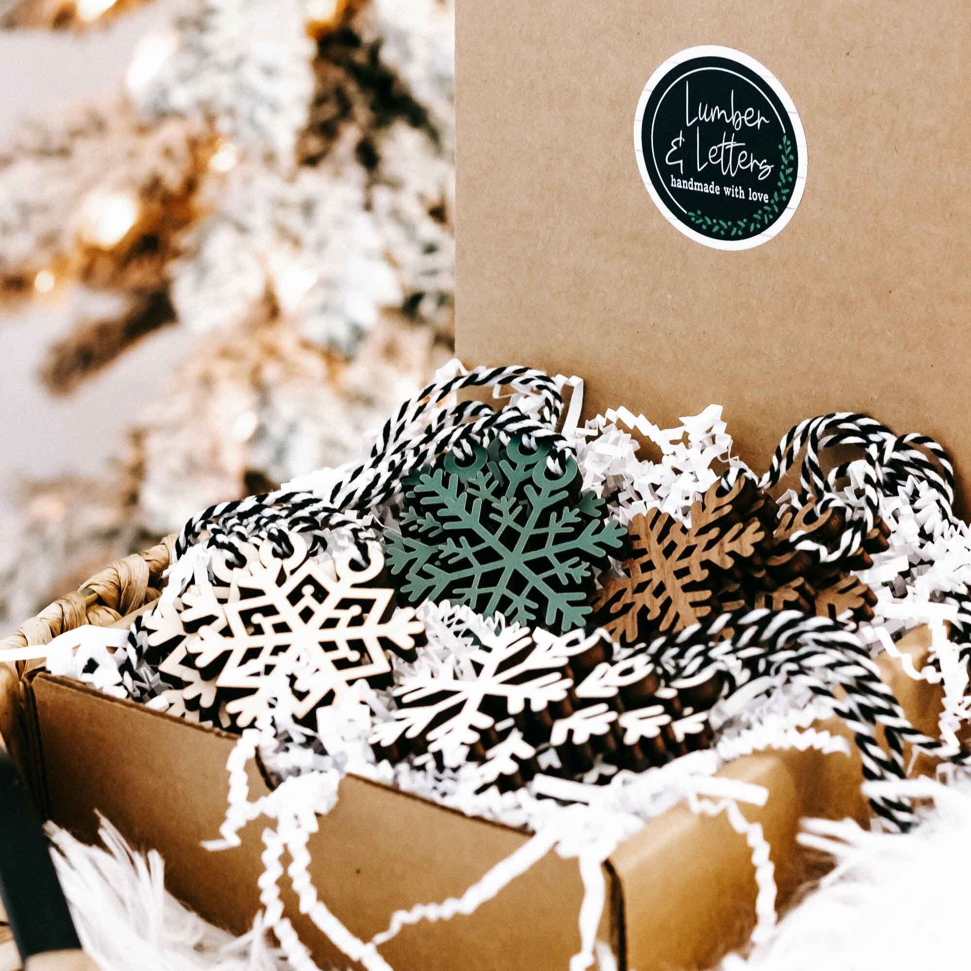 Set of 16 snowflake tree ornaments, white cutout wood with green and dark accents