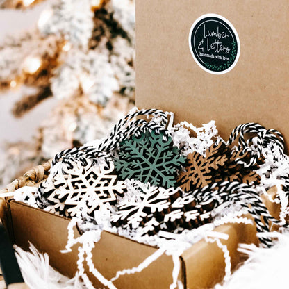 Set of 16 snowflake tree ornaments, white cutout wood with green and dark accents