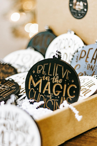 Believe in the magic of Christmas engraved ornament, dark and white with gold accents in box.