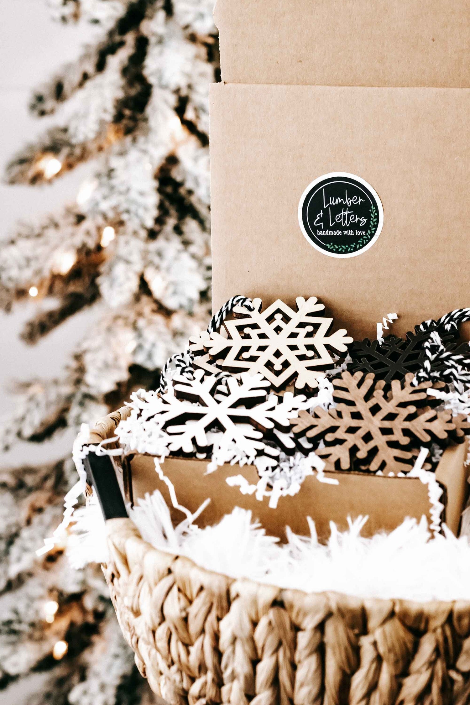 Snowflake ornament set in box: white lattice and dark snowflake cutouts with braided strings