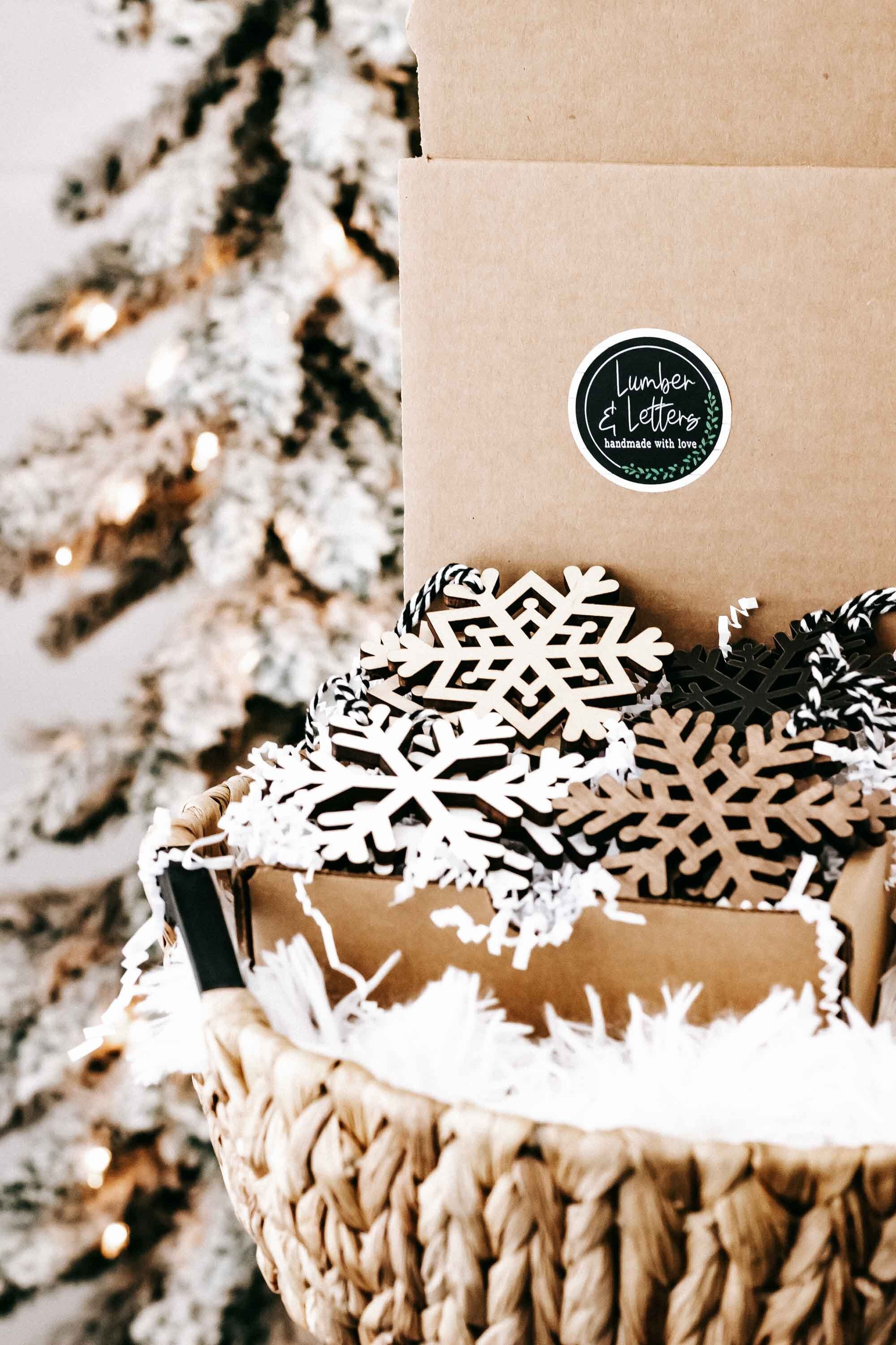 Snowflake ornament set in box: white lattice and dark snowflake cutouts with braided strings
