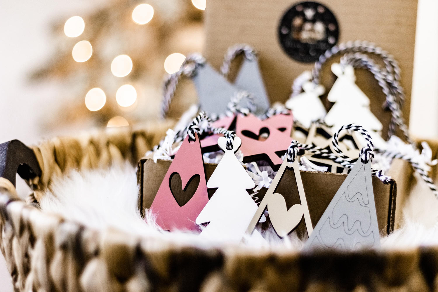 Assorted wooden ornaments with tree shapes and heart cutouts, hanging on braided loops
