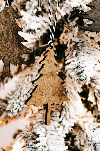 Wooden Christmas tree ornament with black-and-white striped hanging loop and frosted edge.