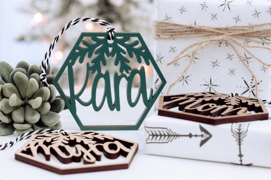 Wood hexagon name ornament with laser-cut leaves and gift box, green and dark