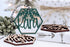 Wood hexagon name ornament with laser-cut leaves and gift box, green and dark