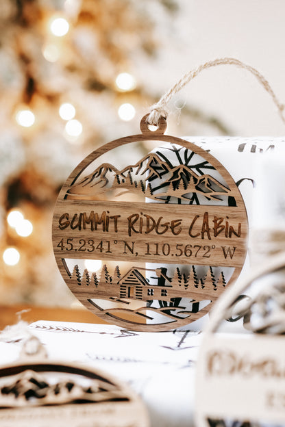 Engraved round wood “SUMMIT RIDGE CABIN” ornament with coordinates, rope hanger