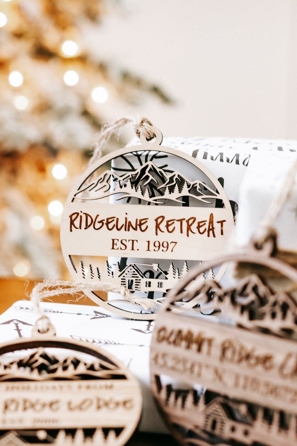 Engraved circular wood cabin ornament with “RIDE... RETREAT” and “EST. 1997” text