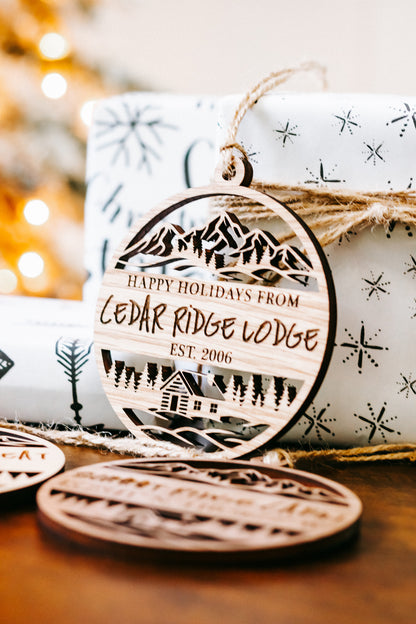 Round engraved wood ornament with “Happy Holidays from Cedar Ridge Lodge” and twine loop