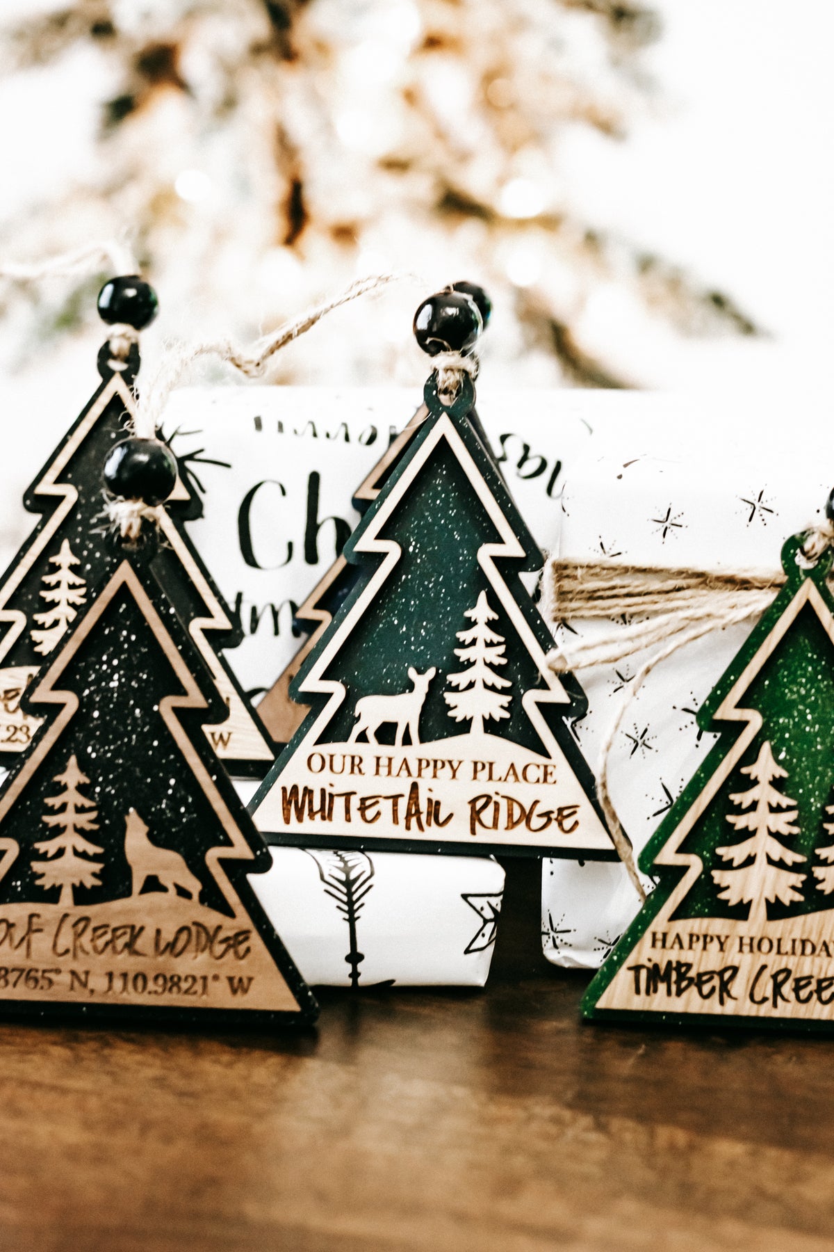 Hanging tree-shaped cabin lodge ornament with dark green foil and star detailing