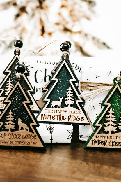 Hanging tree-shaped cabin lodge ornament with dark green foil and star detailing