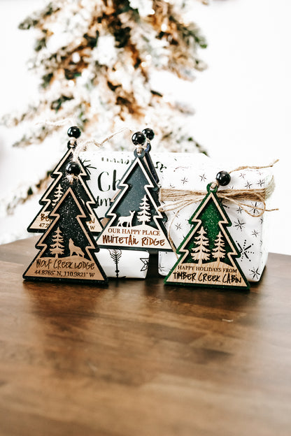 Group of wooden lodge tree ornaments with hanging beads, twine strings, and dark green finish.