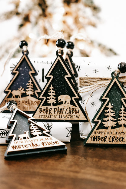 Multiple wooden tree ornaments with hanging beads on twine, dark green centers, gold borders.