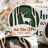 Round wooden Christmas ornament close-up with green deer silhouette and “EST. 2011”