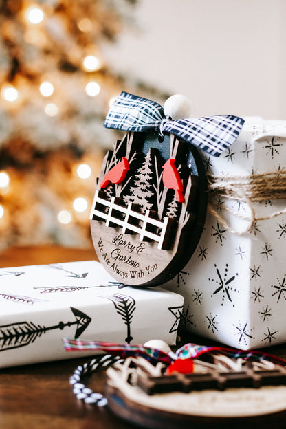 Personalized memorial ornament with red cardinals, plaid bow, forest fence scene