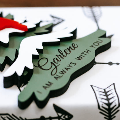 Layered evergreen memorial ornament with gold script name and “Always with you” text