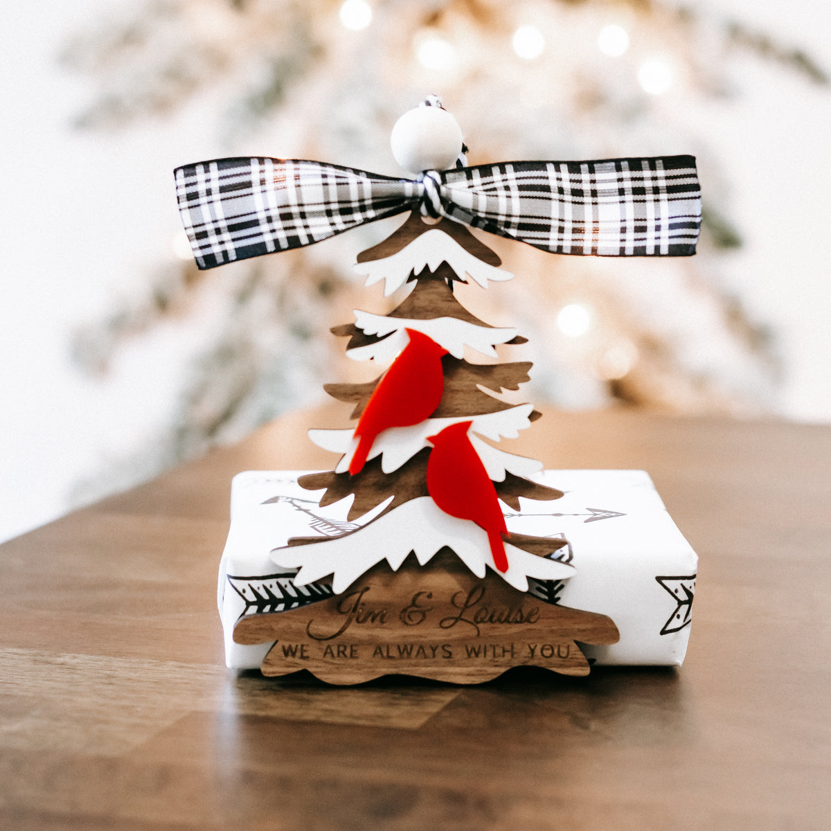 Cardinal memorial Christmas ornament with plaid ribbon bow and layered evergreen trees