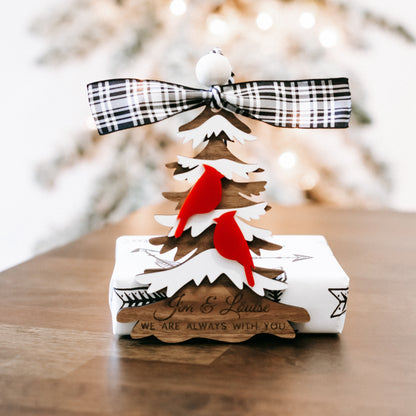 Cardinal memorial Christmas ornament with plaid ribbon bow and layered evergreen trees