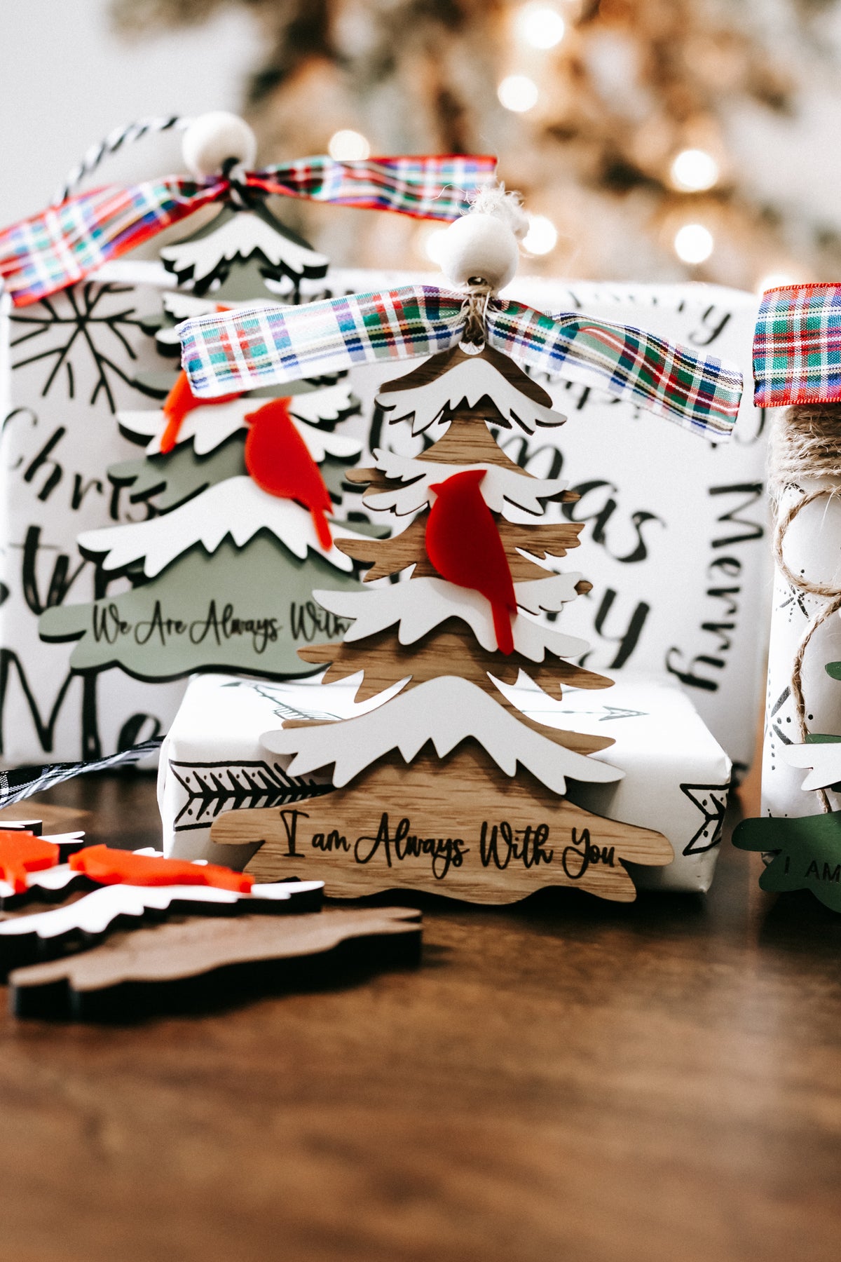 Memorial tree ornament with red cardinals, white cutout trees, plaid ribbon bow, hanging loop