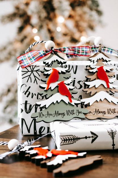 Christmas memorial ornament close-up with plaid bow, red cardinals, and printed message panel