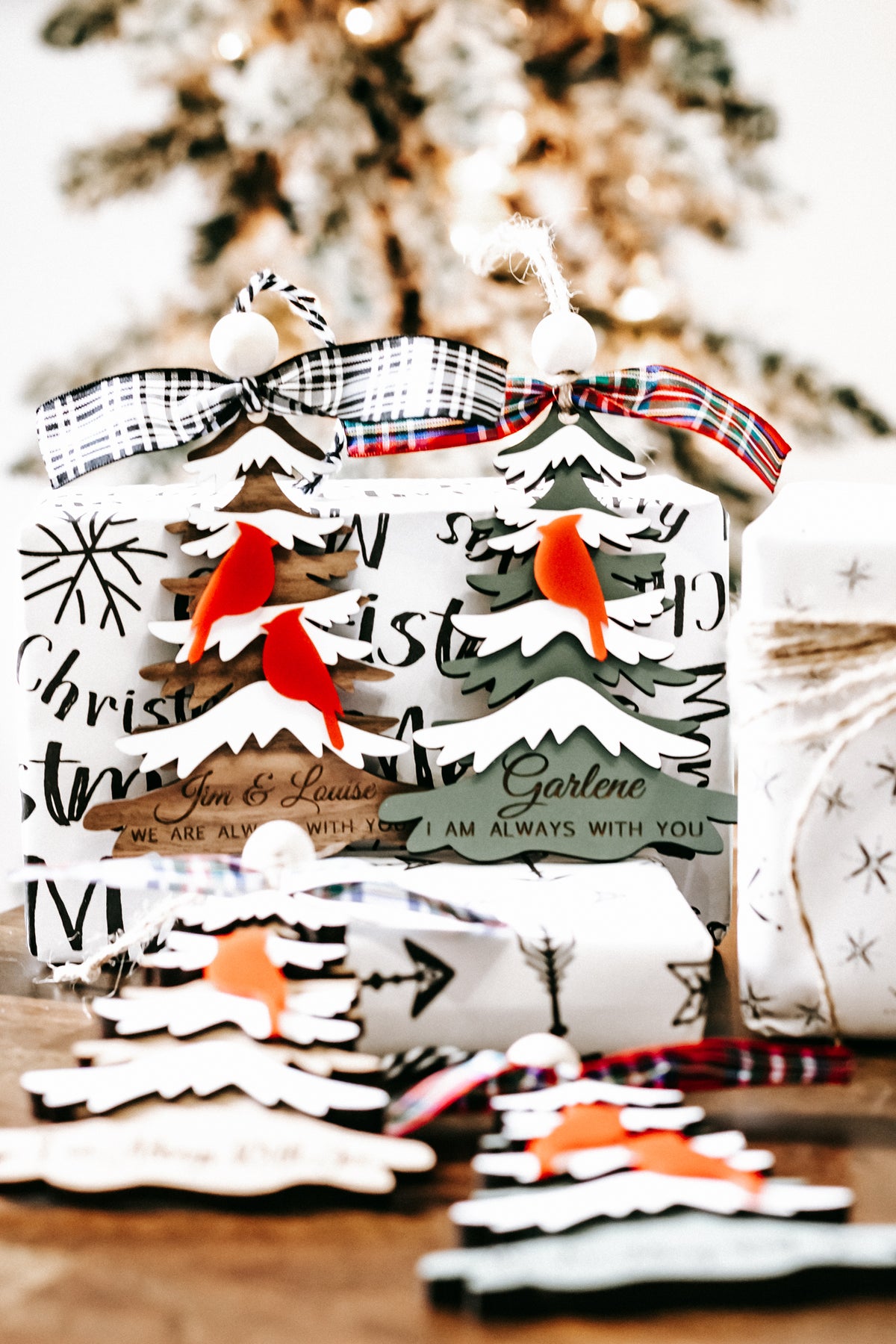 Cardinal memorial Christmas ornament with red cardinals, layered trees, and plaid ribbon