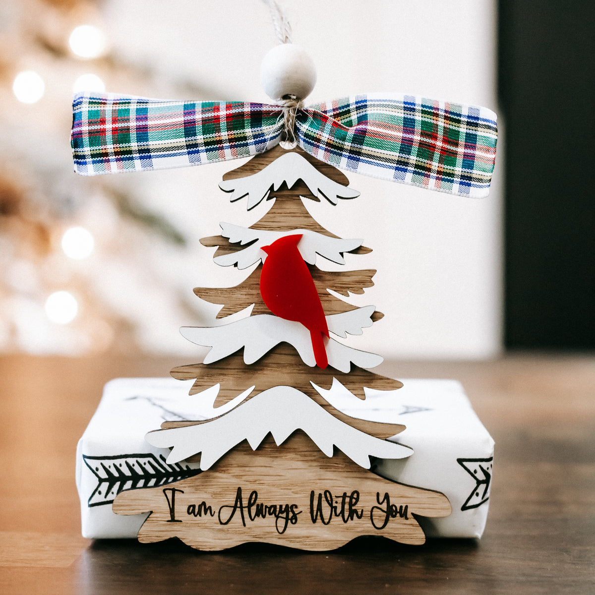 Cardinal memorial Christmas ornament with plaid ribbon bow and white tree cutout design