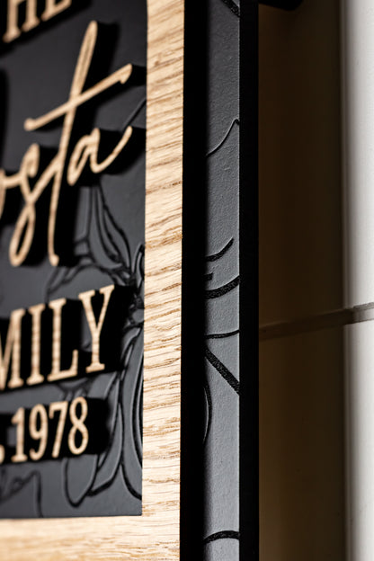 Close-up of framed arch sign edge with light wood frame and black panel