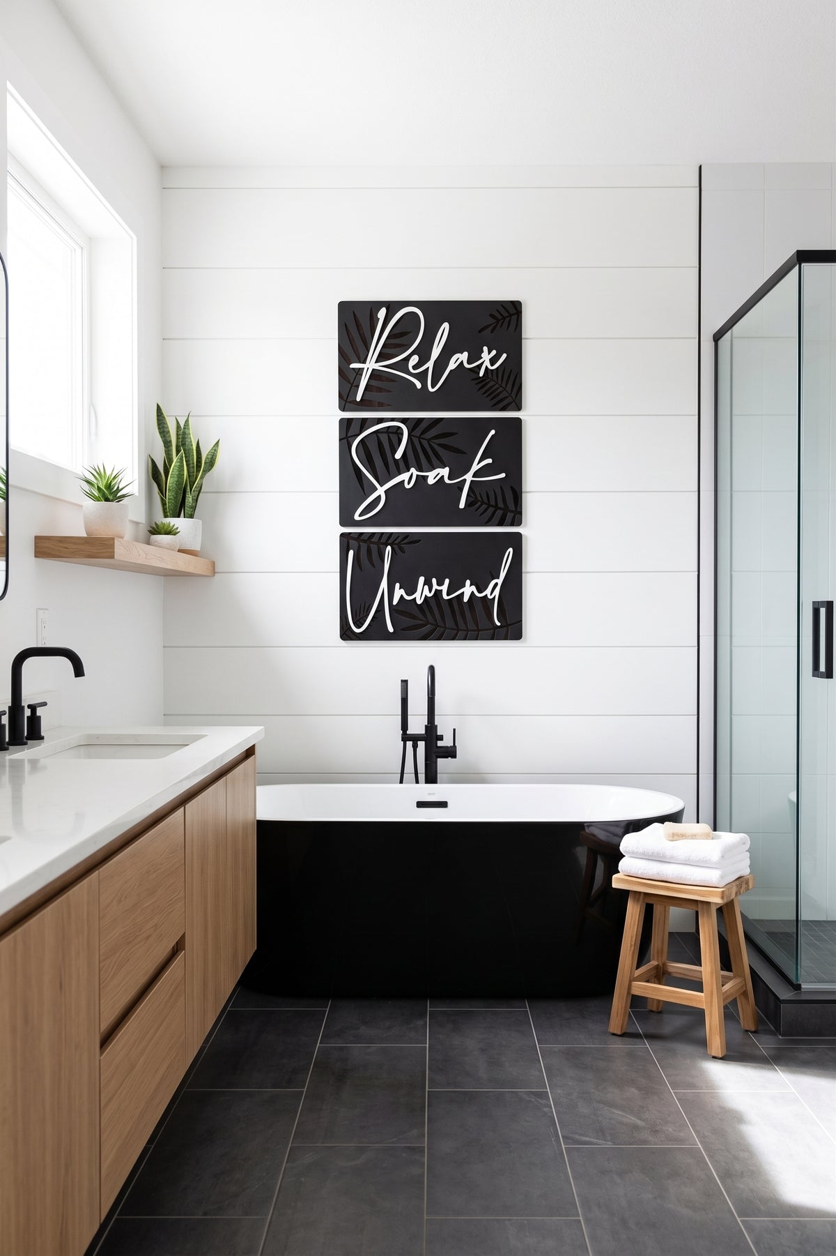 Botanical spa wall art triptych with dark panels, gold leaves, and script “Relax Soak Unwind”