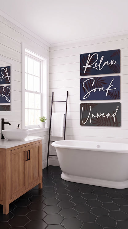 Botanical spa wall art set of three dark panels with gold leaves and script “Relax Soak Unwind”