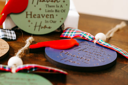 Cardinal memorial ornament close-up with green tag text and red cardinal figure on plaid bow