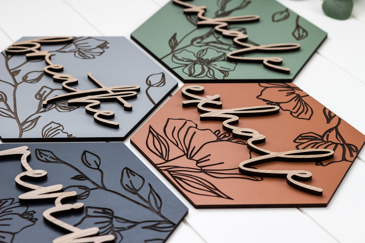 Hexagon wooden wall art set with laser-cut floral engravings in dark and terracotta tones