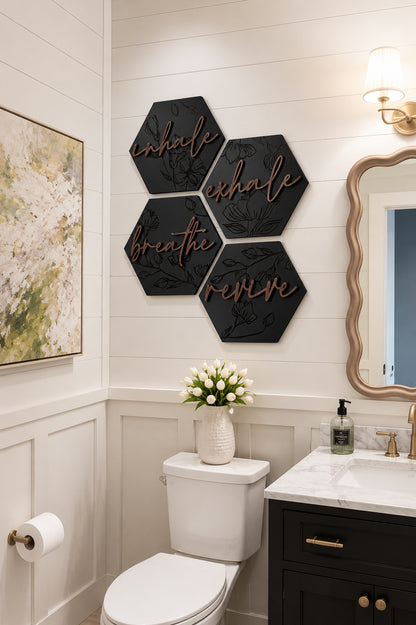Black hexagon wooden wall art set mounted above a toilet with engraved floral script